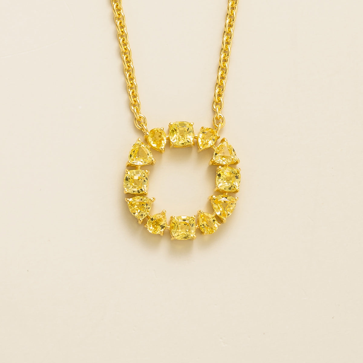 Glorie yellow sapphire open circle pendant necklace in gold, mixed-cut lab-grown sapphires, front view | Juvetti London