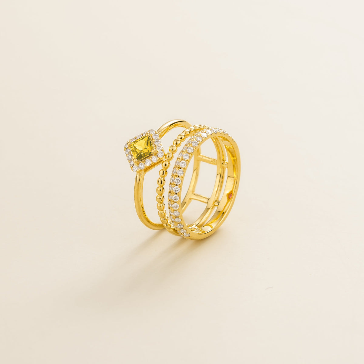 Amici triple-band stacking ring in gold, princess-cut lab-grown yellow sapphire in a diamond halo with beaded and pavé bands, side view | Juvetti London