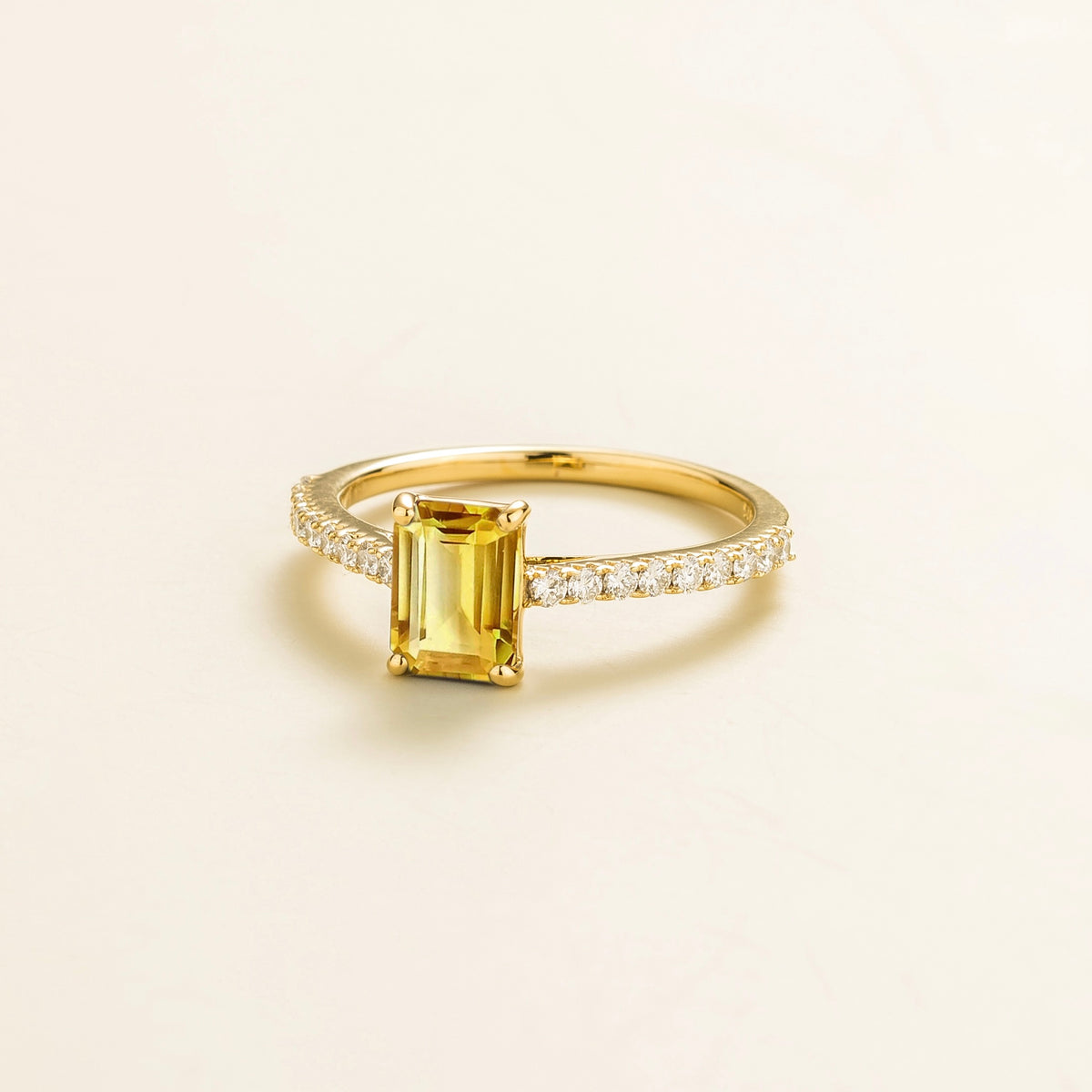 Chelle emerald-cut yellow sapphire and diamond pavé solitaire ring in gold – angle view
