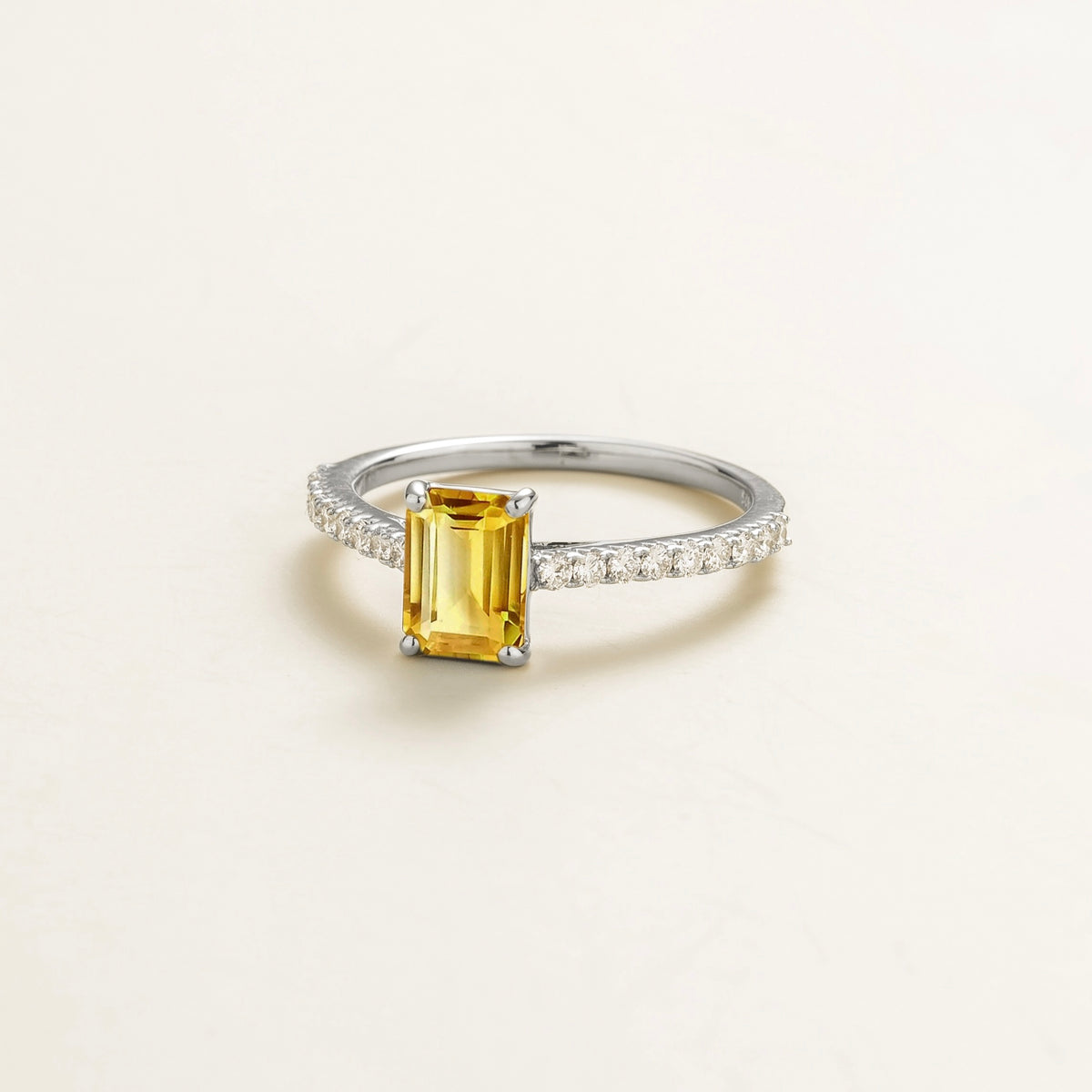 Chelle emerald-cut yellow sapphire and diamond pavé solitaire ring in white gold – angle view