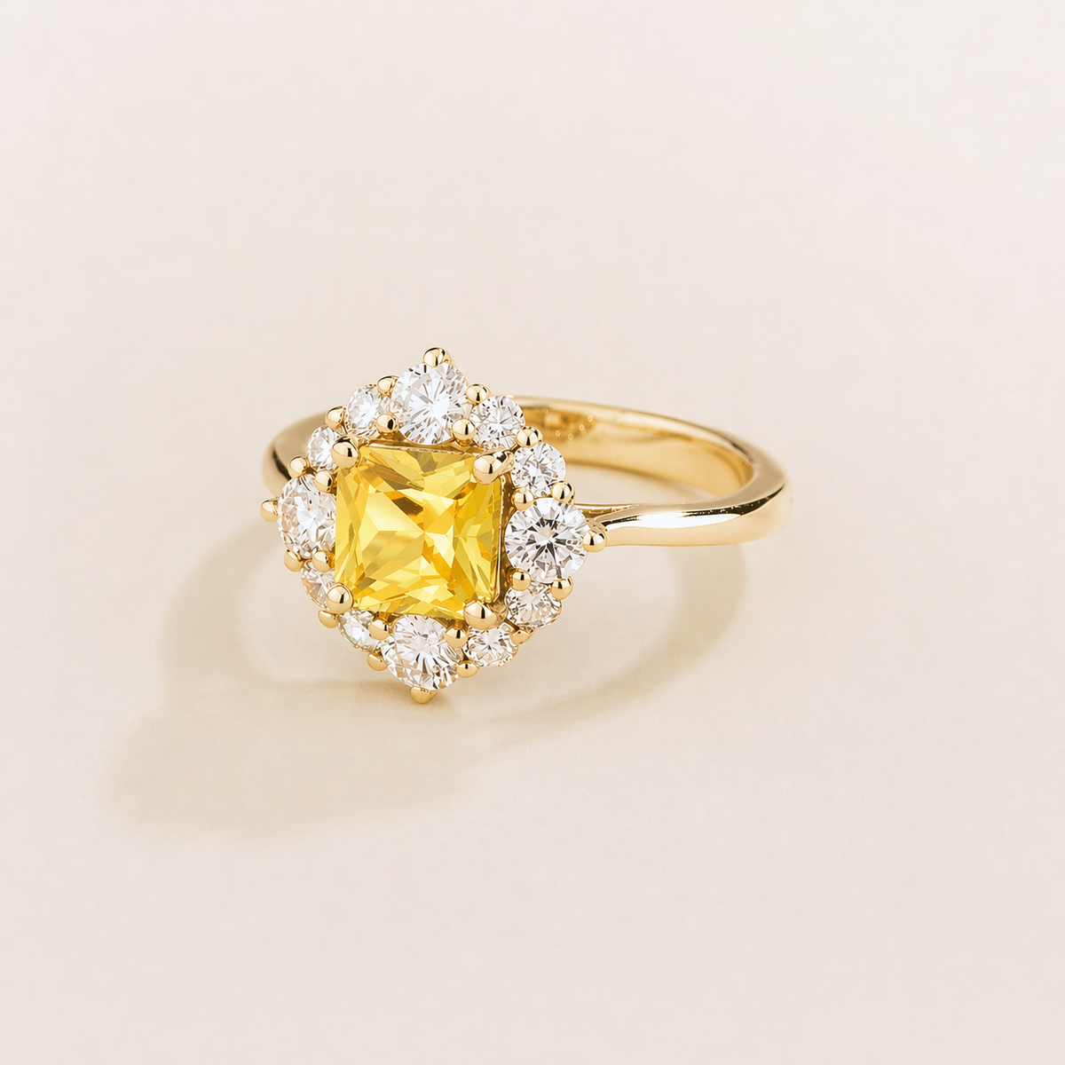 Tuli cushion-cut lab-grown yellow sapphire and diamond halo ring in gold – angle view | Juvetti London