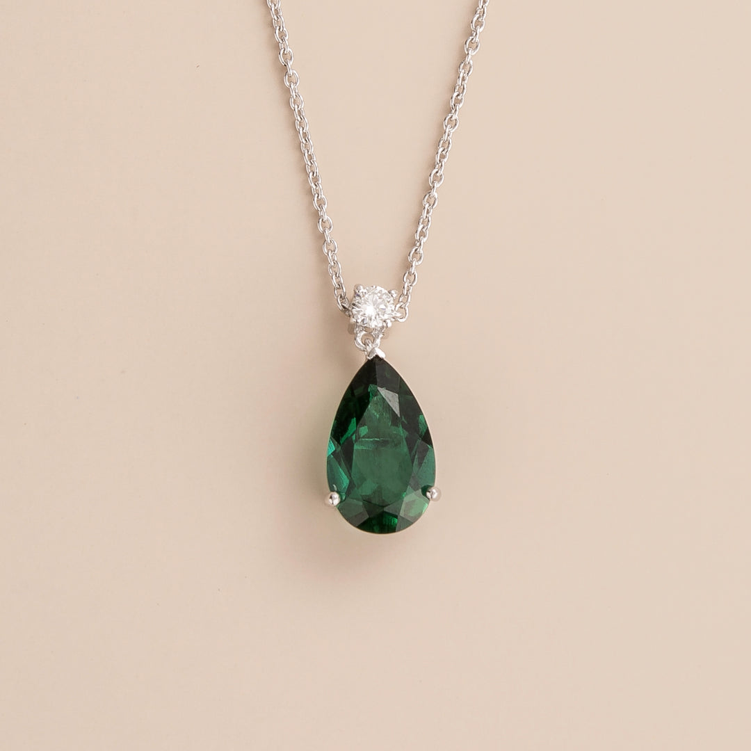 Ori pear drop necklace in 18K white gold vermeil set with lab grown emerald and diamond gem stones.