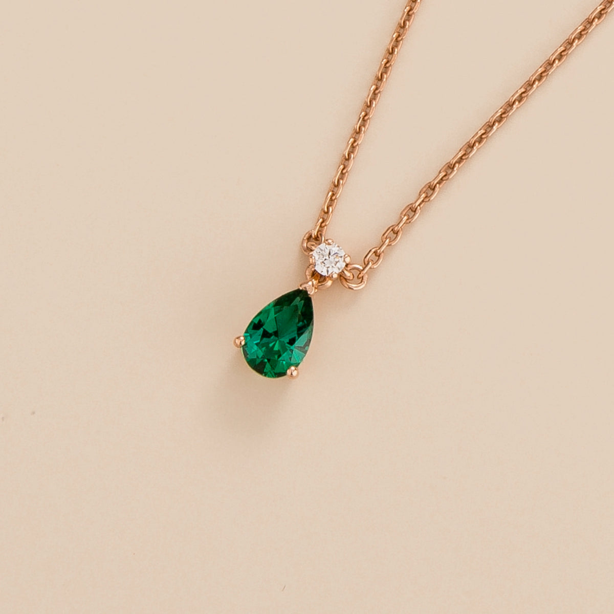 Lab-grown emerald and diamond pear drop pendant necklace in rose gold, small – angled view | Pisa by Juvetti